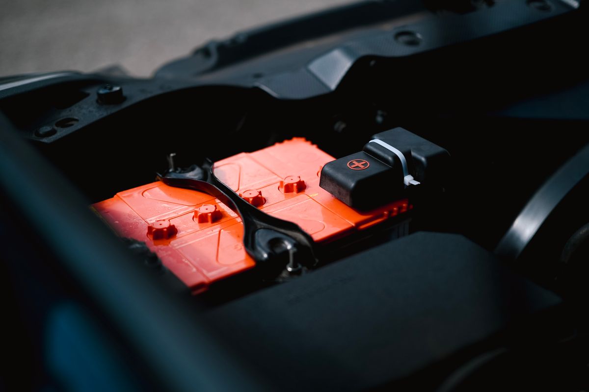 Battery installed inside an engine compartment