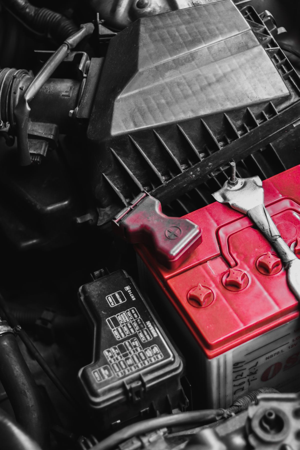 Car battery in an engine bay